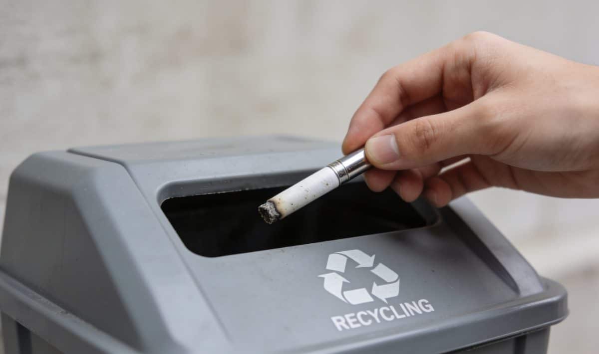 Personne deposant cigarette electronique usagee dans borne recyclage
